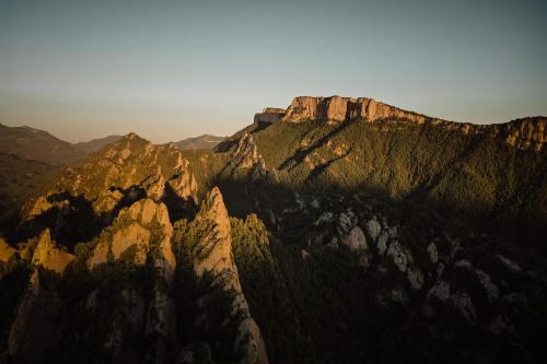 a view of a mountain with the sun shining on it at Hostal Piteus in Sant Llorenc de Morunys