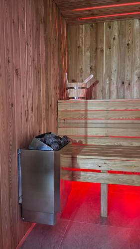 a room with a bench and a wooden wall at Wellness Spa Hotel Zeleni Raj in Banja Luka