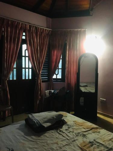 a bedroom with a bed and a large mirror at Home Stay Badulla in Badulla