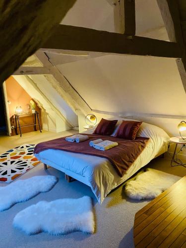 a bedroom with a bed with fuzzy pillows in it at La Maitrise à BAYEUX in Bayeux