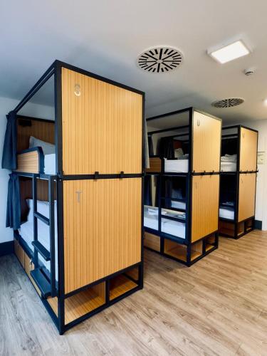 a room with three bunk beds in a room at Aliança café & hostel in Angra do Heroísmo