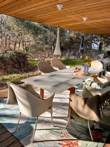 a table and chairs under an umbrella on a patio at Seaside holiday home in Grenå