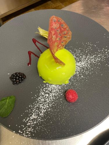 a plate with some food on a table at Logis Hôtel & Restaurant Les Perce-Neige in Bonnétage