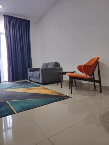 a living room with a couch and a chair at Ainur's Homestay Desaru 2 in Bandar Penawar