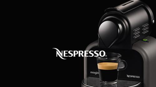 a coffee maker with a cup of coffee at Bio Suites PACINOTTI in Bardolino