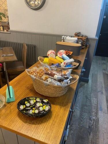 a table with two baskets of food on it at OYO Tamworth Arms Boutique Pub & Hotel in Tamworth
