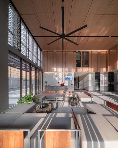 a large lobby with a large ceiling fan at Ramada By Wyndham Bangkok Sukhumvit 87 in Bangkok