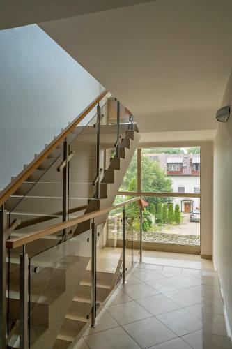 a staircase in a house with a large window at LZ Apartamenty Rewal in Rewal