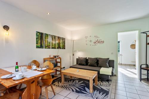 a living room with a couch and a table at Ferienwohnungen Zum Hasenbahnhof in Kirchhundem