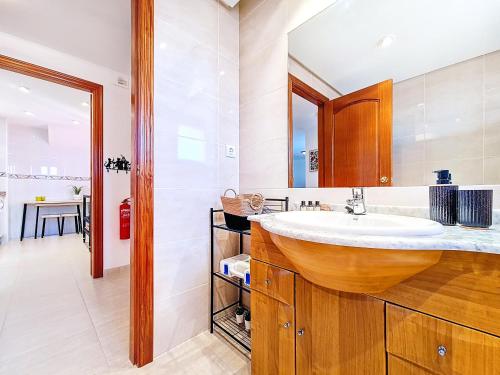 a bathroom with a sink and a mirror at Albatros Playa 2 - 5810 in Mar de Cristal