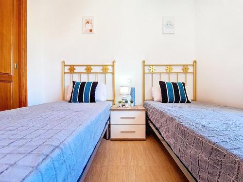 two beds sitting next to each other in a bedroom at Albatros Playa 2 - 5810 in Mar de Cristal