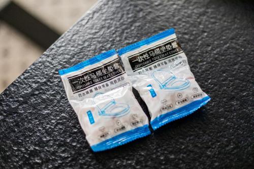 two packets of toothpaste sitting on top of a table at Cheens Hotel in Chengdu