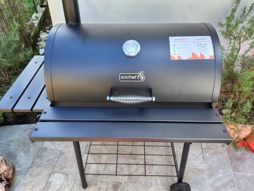 a grill sitting on a bench on a patio at Albert house in La Pescaia