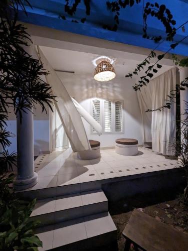 a white room with a staircase and a light at Satta Beach Deluxe in Varkala