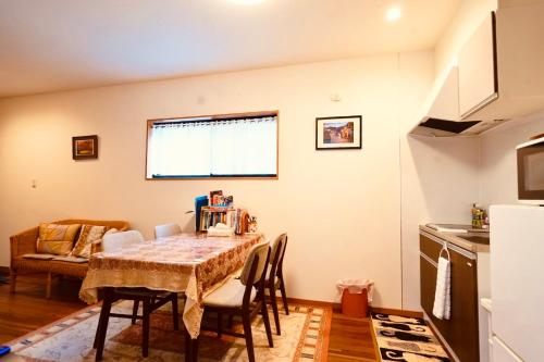 a kitchen and dining room with a table and chairs at 遥華-Haruka House in Kyoto