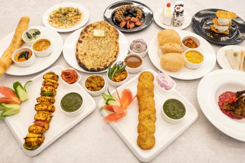 a table full of plates of food with different foods at Sterling Borderland Amritsar in Amritsar