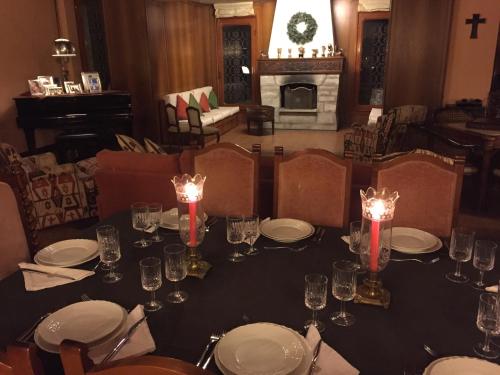 a dining room with a table with plates and glasses at Bed&Garden in Cesate
