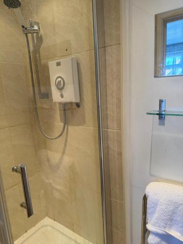 a shower with a glass door in a bathroom at South Sands Hotel in Weston-super-Mare