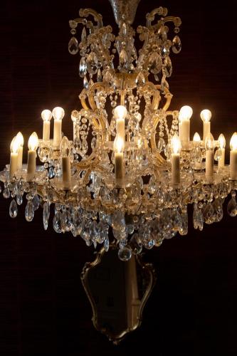 a chandelier with many white candles on it at Les chambres du Waterzooi in Dunkerque