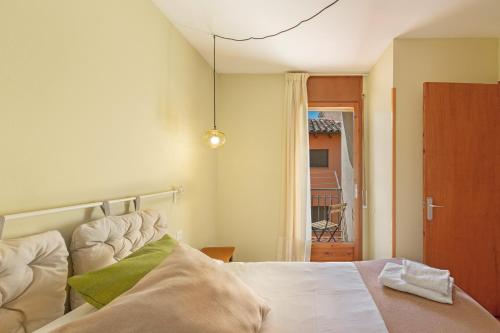 a bedroom with a bed and a door to a balcony at El Portal in Sant Llorenc de Morunys