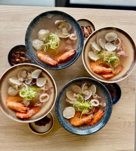 a group of bowls of soup with shrimp and mushrooms at Tidal Stream Sea View B&B in Magong