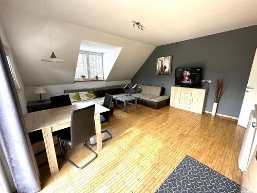 a living room with a couch and a dining room at Apartment Emona Bled 4 in Bled