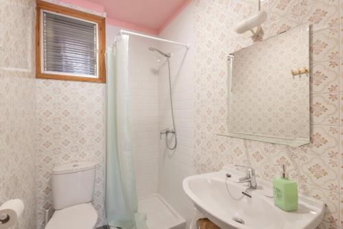 a bathroom with a toilet and a sink and a shower at El Portal in Sant Llorenc de Morunys