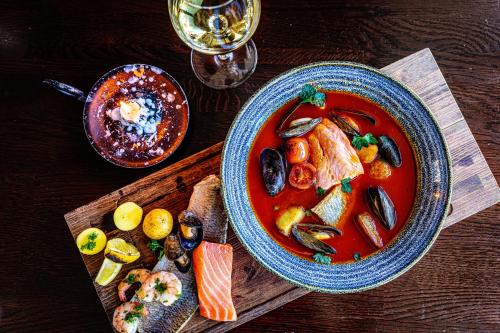 a table with a bowl of soup and a plate of food at Original Sokos Hotel Puijonsarvi in Kuopio