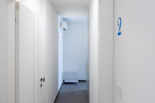 a hallway with white walls and a hallway with a door at Amarena Vacanze in Porto Recanati