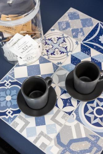 two cups and saucers sitting on a table at Amarena Vacanze in Porto Recanati