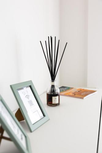 a vase with sticks in it sitting on a table at Amarena Vacanze in Porto Recanati