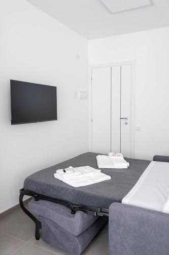 a room with a bed with two towels on it at Amarena Vacanze in Porto Recanati