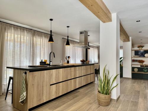 a kitchen with a large island in the middle at Casa Cal Canó in Oliana
