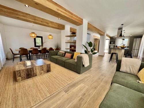 a living room with two couches and a table at Casa Cal Canó in Oliana