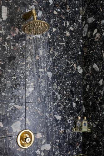 a shower with a shower head in a bathroom at Relais La Foleia - Luxury Villa with private lake in Veruno