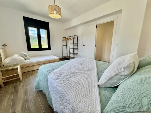 a bedroom with a bed and a window at Casa Cal Canó in Oliana
