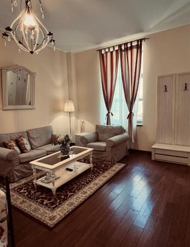 a living room with a couch and a coffee table at Park Villa - Boutique Hotel in Timişoara