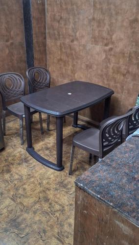 a black table and chairs in a room at Sheetal Dormitoy in Mumbai