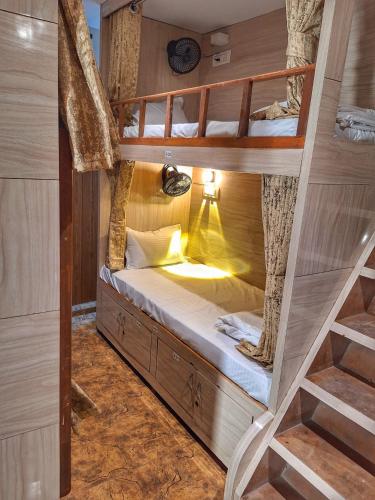 a bedroom with a bunk bed in a tree house at Sheetal Dormitoy in Mumbai
