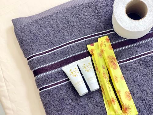 a table with towels and a roll of toilet paper at SKY VILLA - BKK Phnom Penh - Rooms & Apartments - FREE LAUNDRY in Phnom Penh
