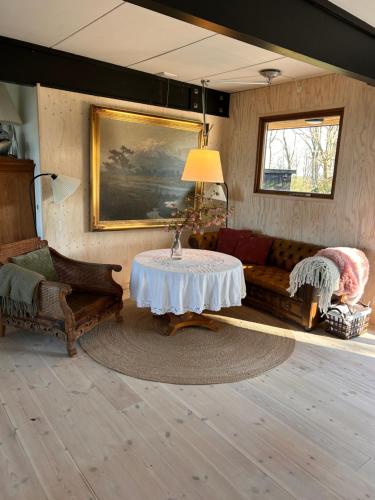 a living room with a table and a couch at Seaside holiday home in Grenå