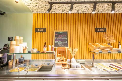 a fast food restaurant with a yellow wall at Penzion Nad Lávkou in Uherský Brod