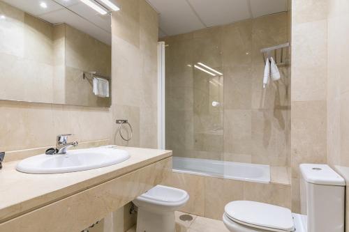 a bathroom with a sink and a toilet and a shower at Plaza Mayor by Forever Rentals in Madrid