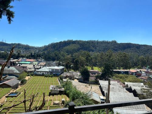 a view of a small village with a mountain at Premier Villa in Nuwara Eliya