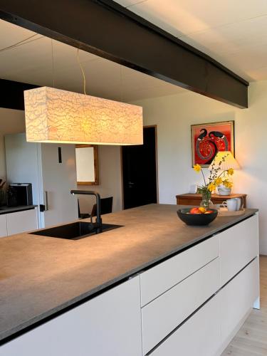 a kitchen with a counter with a sink at Seaside holiday home in Grenå
