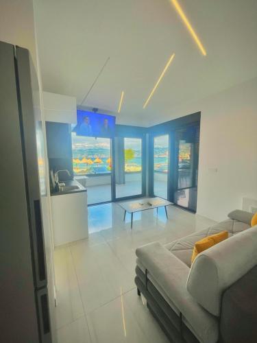 a living room with a couch and a table at Villa San Sebastian - apartments on the beach with jacuzzi in Baška