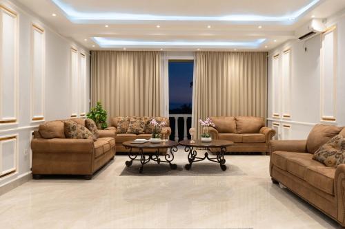 a living room with two couches and a table at Place of Power in Blahbatu