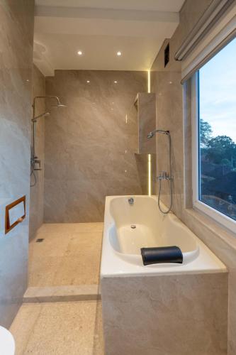 a bathroom with a white sink and a shower at Place of Power in Blahbatu