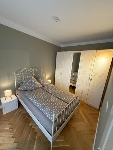 a bedroom with a bed and white cabinets at Schöne und zentrale Altbauwohnung in Gießen in Gießen