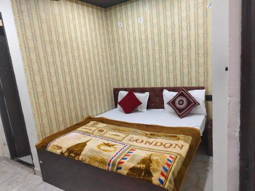 a bedroom with a bed with pillows on it at Govind Residency Near India Expo Mart Greater Noida in Greater Noida